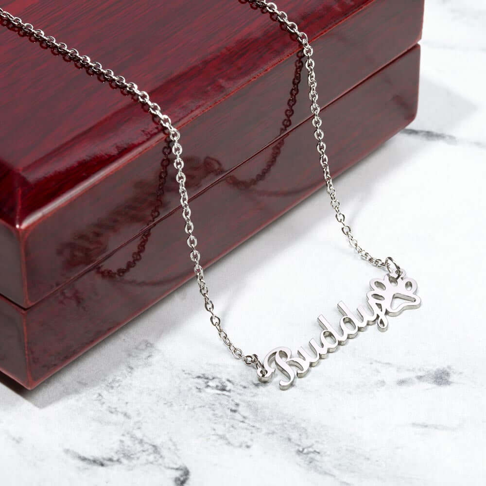 Personalized More Than Charms name necklace with paw print on elegant box, perfect gift for pet lovers.